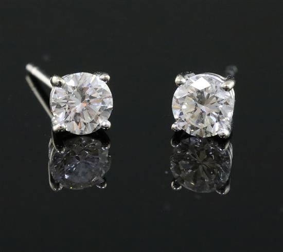 A pair of 18ct white gold and solitaire diamond ear studs,